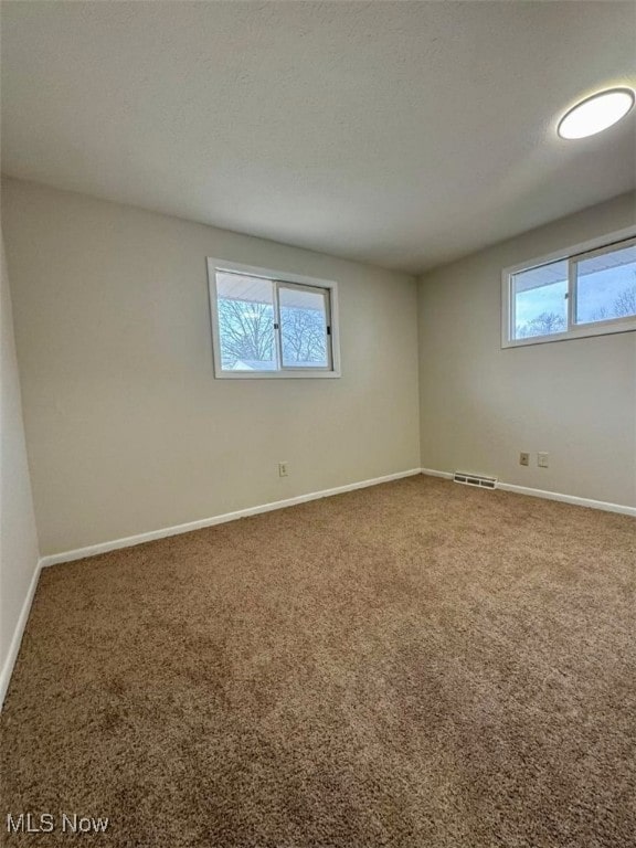 233 Kennedy St, Louisville, OH 44641 - empty room featuring plenty of natural light and carpet