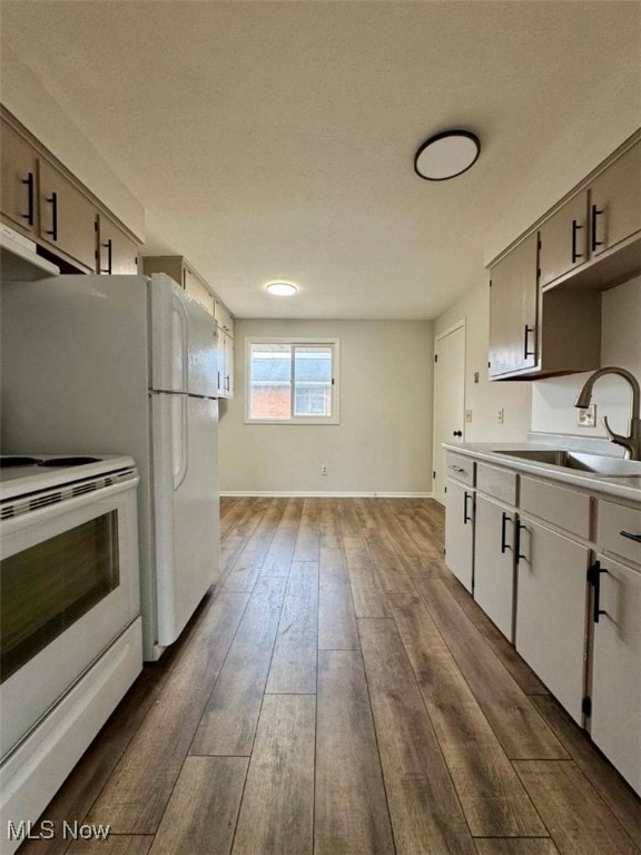 233 Kennedy St, Louisville, OH 44641 - kitchen with white appliances, dark wood finished floors, light countertops, and under cabinet range hood
