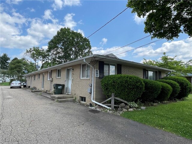 233 Kennedy St, Louisville, OH 44641 - view of property exterior featuring brick siding