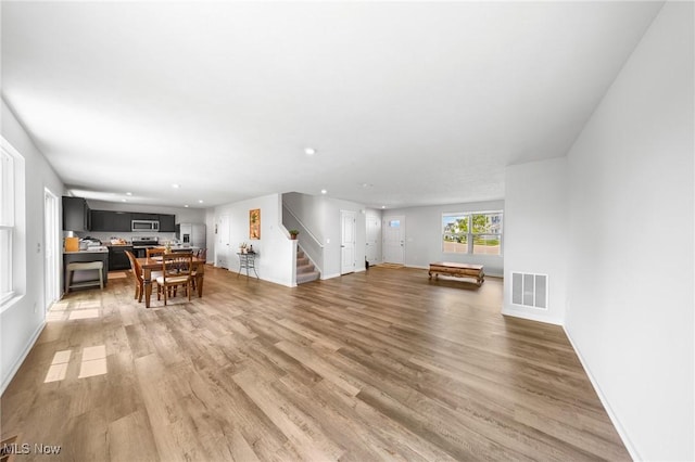2457 Bishop Oval, Barberton, OH 44203 - living area with stairs, light wood-style floors, and recessed lighting