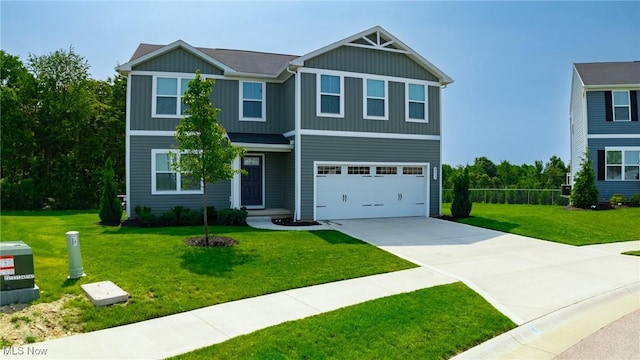 2457 Bishop Oval, Barberton, OH 44203 - view of front facade with a garage, driveway, and board and batten siding