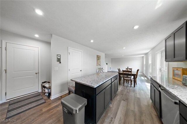 2457 Bishop Oval, Barberton, OH 44203 - kitchen with dishwasher, dark wood-style floors, recessed lighting, a kitchen island, and light stone countertops