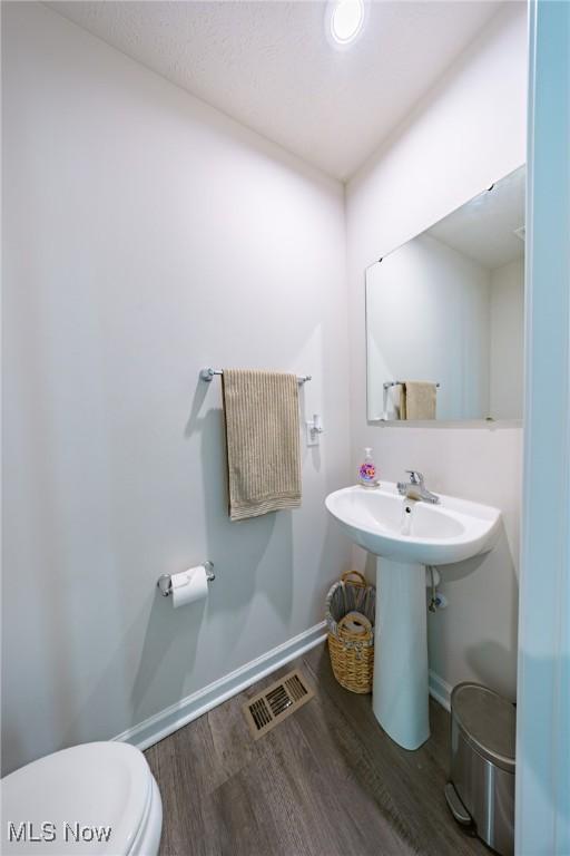 2457 Bishop Oval, Barberton, OH 44203 - half bathroom featuring baseboards and wood finished floors