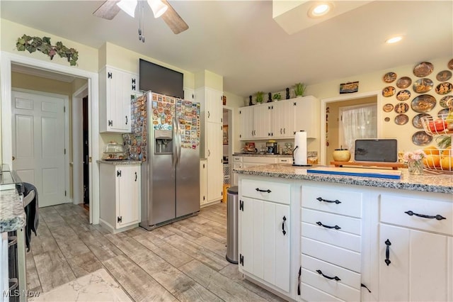 1201 Overlook Dr, Alliance, OH 44601 - kitchen with stainless steel refrigerator with ice dispenser, white cabinetry, a ceiling fan, light stone counters, and light wood-style flooring