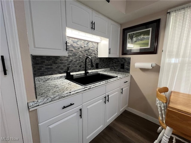 1749 Highview Ave, Akron, OH 44301 - kitchen with decorative backsplash, dark wood-style flooring, white cabinets, and light stone countertops