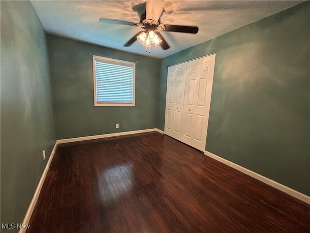 1312 Glennview St NE, Canton, OH 44721 - unfurnished bedroom featuring dark wood-type flooring, a closet, and ceiling fan