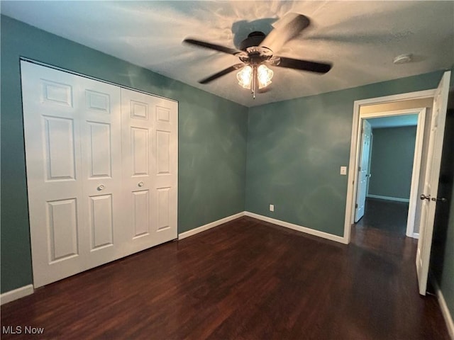 1312 Glennview St NE, Canton, OH 44721 - unfurnished bedroom with dark wood-style floors, a closet, and ceiling fan