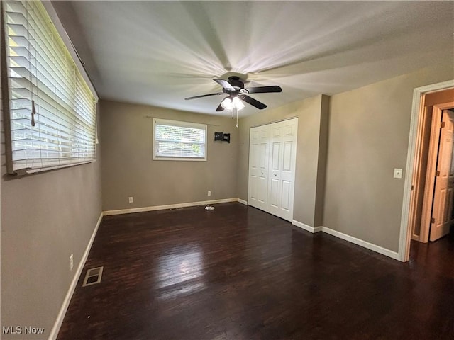 1312 Glennview St NE, Canton, OH 44721 - unfurnished bedroom with dark wood-type flooring, a closet, and ceiling fan