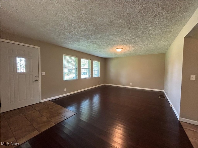 1312 Glennview St NE, Canton, OH 44721 - foyer entrance featuring wood finished floors and a textured ceiling