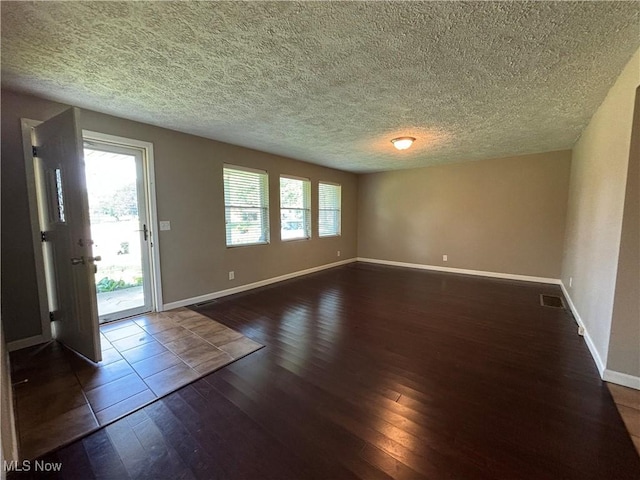 1312 Glennview St NE, Canton, OH 44721 - empty room with dark wood-style floors and a textured ceiling