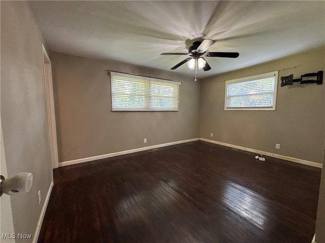 1312 Glennview St NE, Canton, OH 44721 - empty room featuring plenty of natural light, dark wood-style floors, and a ceiling fan