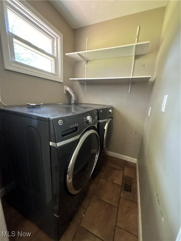 1312 Glennview St NE, Canton, OH 44721 - laundry area featuring washing machine and dryer and dark tile patterned floors