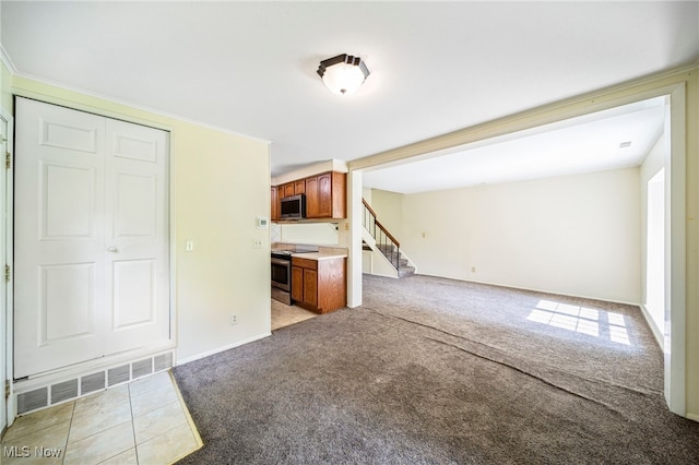 7297 Trotter Ln Unit B, Mentor, OH 44060 - unfurnished living room featuring light carpet and stairway