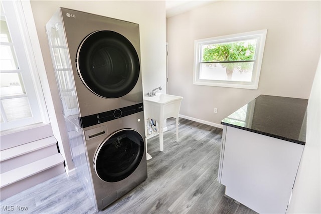 6580 Crossview Rd, Seven Hills, OH 44131 - laundry room featuring stacked washer and clothes dryer and light wood-type flooring
