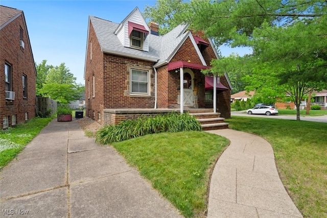 16200 Elsienna Ave, Cleveland, OH 44135 - view of front facade featuring brick siding, a chimney, cooling unit, and roof with shingles
