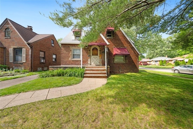 16200 Elsienna Ave, Cleveland, OH 44135 - tudor home featuring brick siding, a front yard, and cooling unit