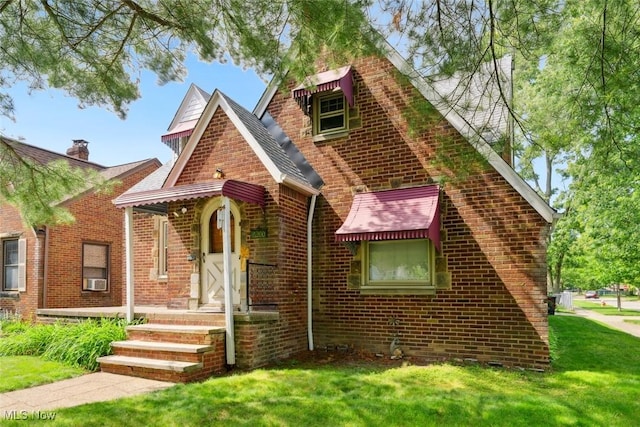 16200 Elsienna Ave, Cleveland, OH 44135 - tudor-style house featuring brick siding, a front yard, and roof with shingles