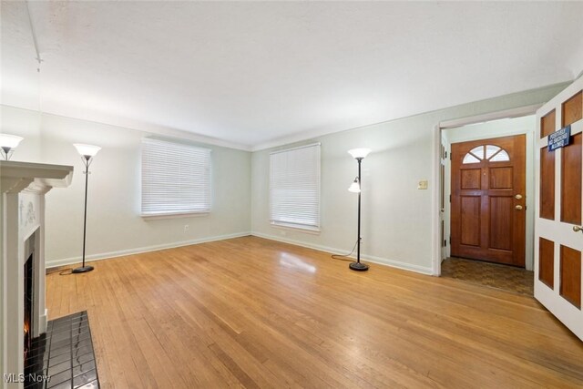 16200 Elsienna Ave, Cleveland, OH 44135 - entryway with light wood-style flooring and a lit fireplace