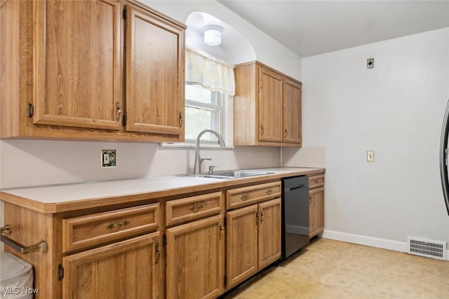 16200 Elsienna Ave, Cleveland, OH 44135 - kitchen featuring dishwasher, light countertops, and brown cabinetry