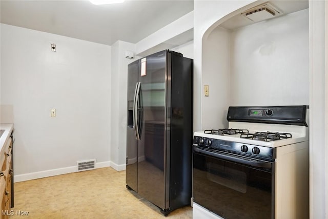16200 Elsienna Ave, Cleveland, OH 44135 - kitchen featuring gas range, refrigerator with ice dispenser, light colored carpet, and arched walkways