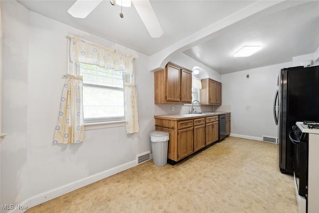 16200 Elsienna Ave, Cleveland, OH 44135 - kitchen with black dishwasher, stove, brown cabinets, a ceiling fan, and light countertops