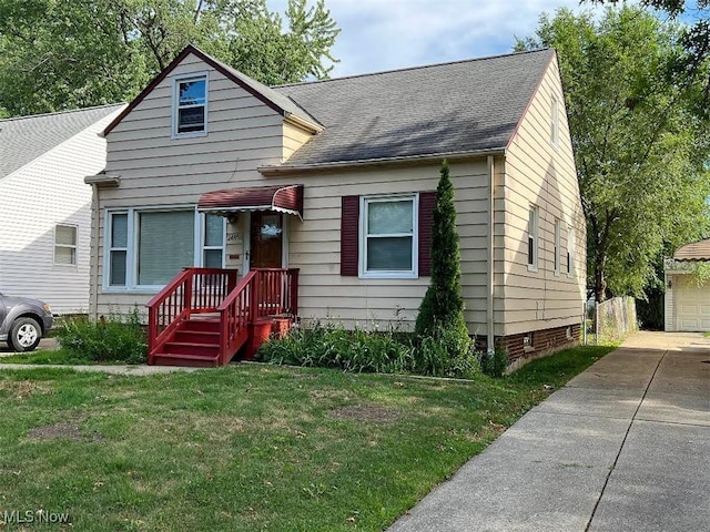 24850 Zeman Ave, Euclid, OH 44123 - bungalow-style home with a front lawn, roof with shingles, an outdoor structure, and a garage