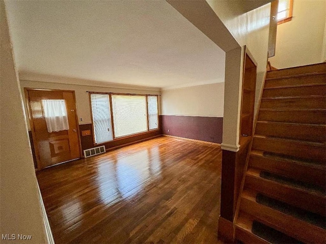 24850 Zeman Ave, Euclid, OH 44123 - unfurnished living room with dark wood-type flooring, plenty of natural light, and stairs