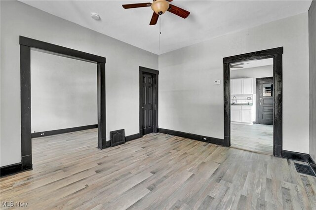 3620 E 63rd St, Cleveland, OH 44105 - spare room with a ceiling fan and light wood-style floors