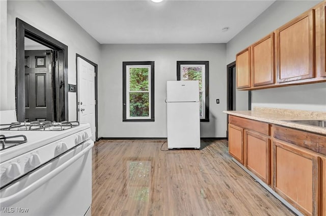 3620 E 63rd St, Cleveland, OH 44105 - kitchen featuring white appliances, light countertops, and light wood-style floors