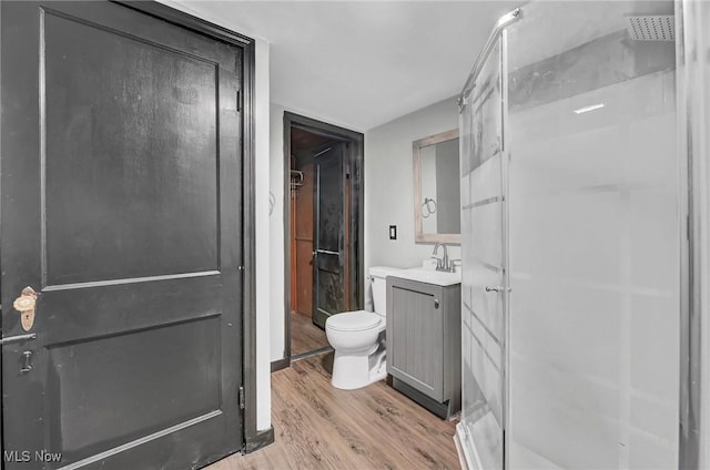 3620 E 63rd St, Cleveland, OH 44105 - bathroom with a stall shower, wood finished floors, and vanity