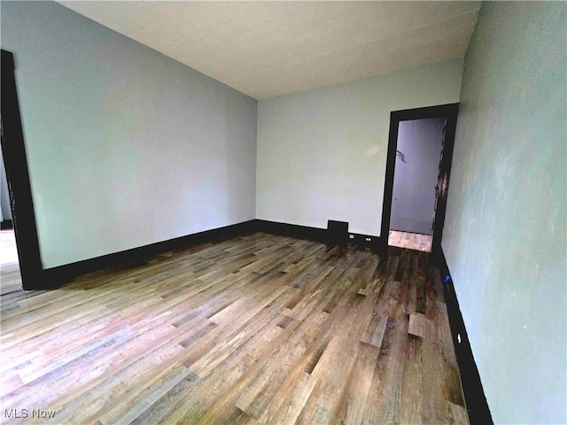 3620 E 63rd St, Cleveland, OH 44105 - spare room featuring wood finished floors and baseboards