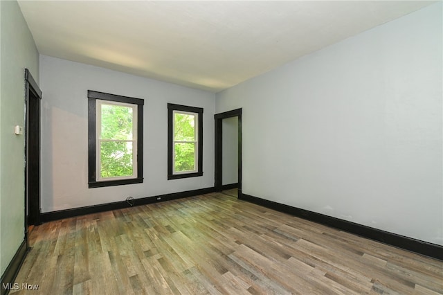 3620 E 63rd St, Cleveland, OH 44105 - spare room featuring wood finished floors and baseboards