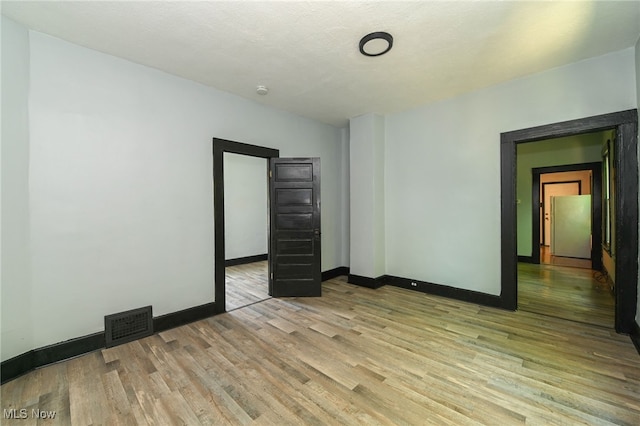 3620 E 63rd St, Cleveland, OH 44105 - empty room with light wood-style floors and baseboards