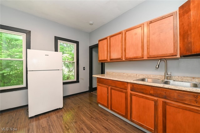 3620 E 63rd St, Cleveland, OH 44105 - kitchen with freestanding refrigerator, light countertops, dark wood finished floors, and brown cabinets
