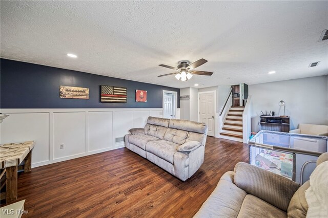 350 Townline Rd, Aurora, OH 44202 - living room featuring wood finished floors, ceiling fan, stairs, a textured ceiling, and a decorative wall
