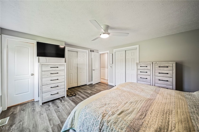 350 Townline Rd, Aurora, OH 44202 - bedroom featuring wood finished floors, multiple closets, a ceiling fan, and a textured ceiling