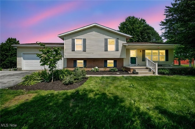 350 Townline Rd, Aurora, OH 44202 - split level home with an attached garage, asphalt driveway, a front lawn, and a porch