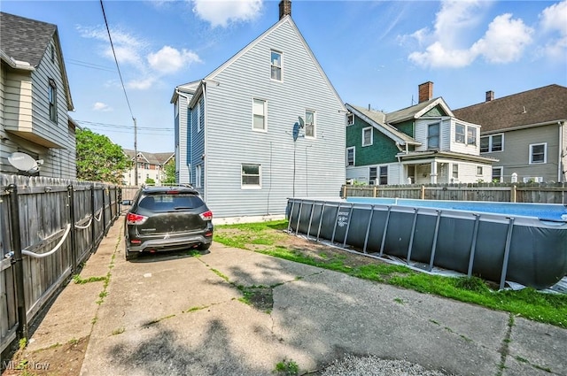 3676 E 69th St, Cleveland, OH 44105 - rear view of house with a fenced backyard and a residential view