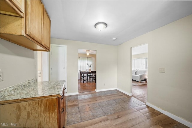 1369 Adelaide Ave SE, Warren, OH 44484 - kitchen with plenty of natural light, light countertops, ceiling fan, and light stone finish flooring