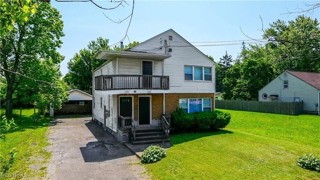 1369 Adelaide Ave SE, Warren, OH 44484 - traditional-style home featuring a balcony, covered porch, and driveway
