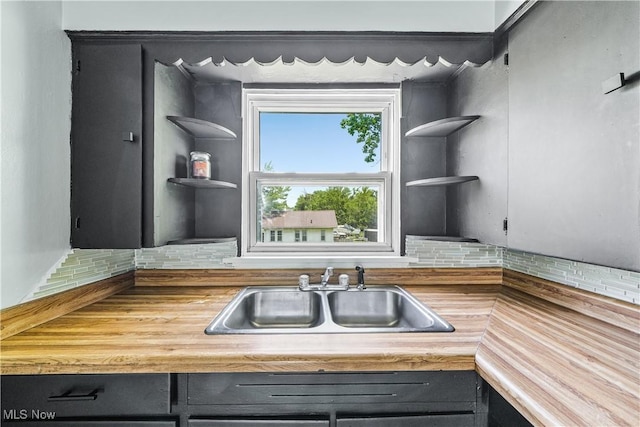 1369 Adelaide Ave SE, Warren, OH 44484 - kitchen with open shelves, backsplash, and wooden counters