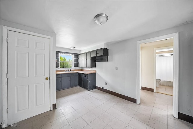1369 Adelaide Ave SE, Warren, OH 44484 - kitchen featuring light countertops, open shelves, and light tile patterned flooring