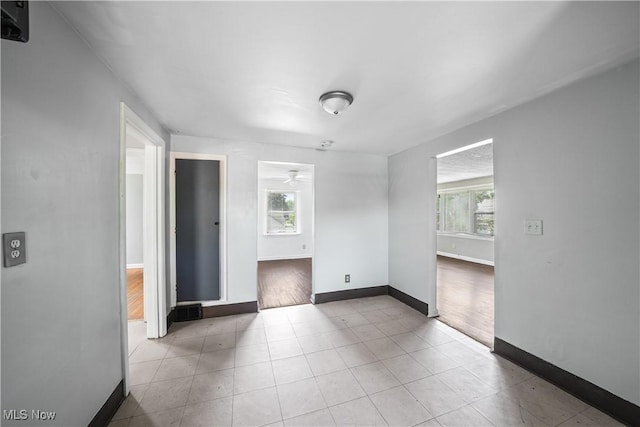1369 Adelaide Ave SE, Warren, OH 44484 - unfurnished room featuring plenty of natural light, ceiling fan, and tile patterned flooring
