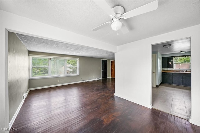 1369 Adelaide Ave SE, Warren, OH 44484 - empty room with wood finished floors, plenty of natural light, a ceiling fan, and a textured ceiling