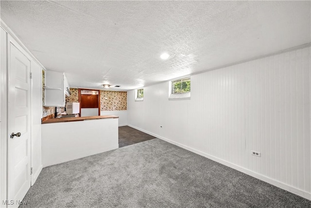 1369 Adelaide Ave SE, Warren, OH 44484 - unfurnished living room featuring dark carpet and a textured ceiling