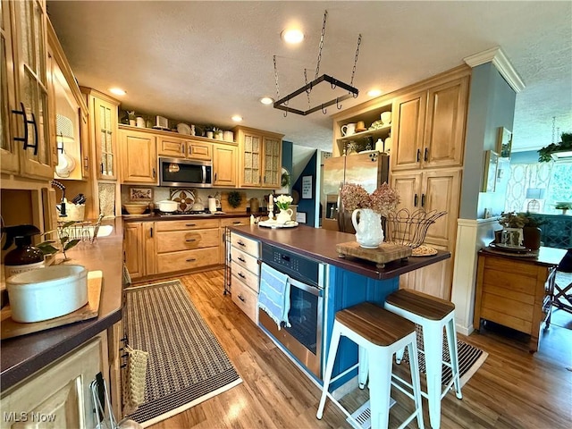 14003 N Highview Dr, Dalton, OH 44618 - kitchen featuring stainless steel appliances, dark countertops, light wood-type flooring, glass insert cabinets, and recessed lighting