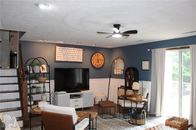 14003 N Highview Dr, Dalton, OH 44618 - living room featuring a ceiling fan, wainscoting, stairs, and a textured ceiling