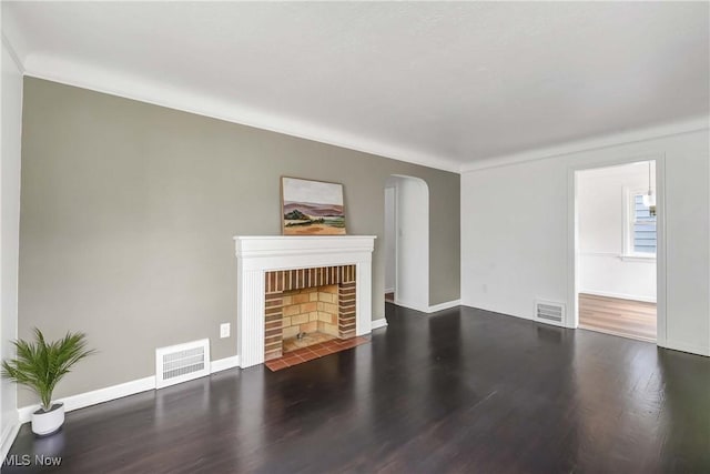 4328 W 56th St, Cleveland, OH 44144 - unfurnished living room featuring wood finished floors, arched walkways, and a fireplace