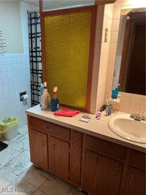 925 Ohio Ave, Mcdonald, OH 44437 - bathroom with tile walls, vanity, marble look tile flooring, curtained shower, and decorative backsplash