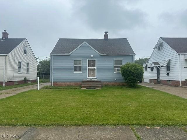 20371 Morris Ave, Euclid, OH 44123 - view of front of house with a front lawn, a chimney, and entry steps